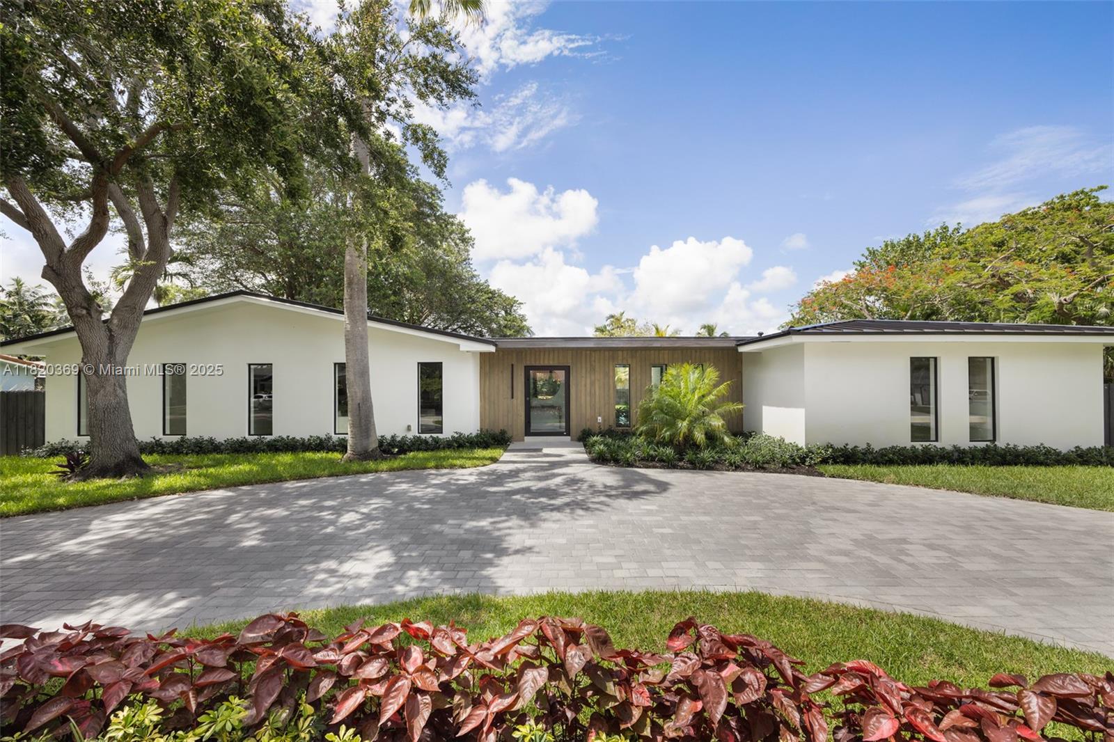 A bold reimagining by the Angelo Gerard Group, this custom-designed corner-lot home pairs architectural elegance with modern functionality. Italian porcelain floors, rare marble accents, and custom cabinetry define the open-concept interiors. The chef’s kitchen flows effortlessly into expansive living areas and a private primary suite with midnight kitchen, spa bath, and custom closet. Slide open the impact doors to reveal a lush, resort-style backyard with a magical banyan tree and new pool. Minutes from top private schools.