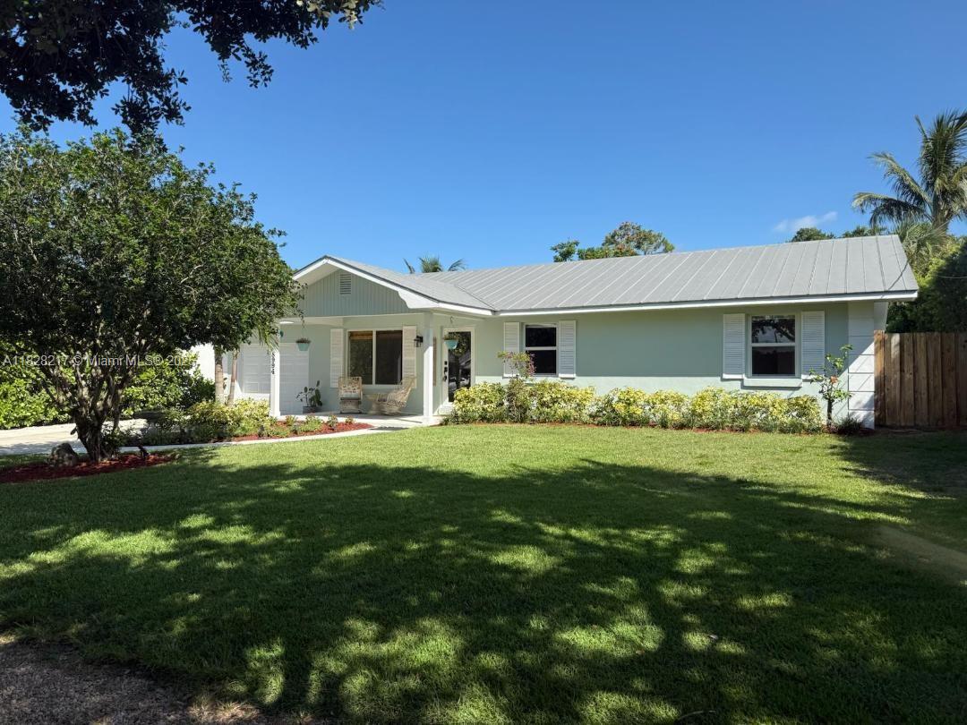 Tucked in a serene & private enclave off Gomez, this completely RENOVATED, move in ready home is 1 MILE FROM HOBE SOUND BEACH! Lush landscape, freshly painted exterior, new impact windows & doors that let in tons of natural light. Inside, enjoy an open concept layout. The newly renovated kitchen offers quartz countertops, newer SS appliances, large island, pot filler, pantry & coffee station. A flex room serves as a 4th bedroom, office, playroom. The spacious primary suite features his AND her closets & a spa like shower with dual rain shower heads. NEW waterproof laminate flooring installed 2025, NO CARPET! Outside enjoy the large covered patio, fully fenced yard, outdoor shower & beautiful landscaping to ensure privacy with plenty of room for a pool. Aquaphor feeds pristine well water!