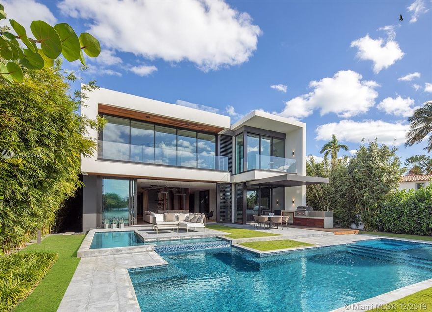 Ultra-high-end luxury waterfront on the Venetian Islands in Miami Beach facing West & offering incredible Miami Skyline & sunset views! Built in 2019, this modern masterpiece features an open concept floor-plan with a family room, glass-enclosed office/bar, dining area, Boffi kitchen, & living room with powered sliding doors. Finishes include: exquisite Listone Giordano oak floors, Savant control system, 10’ ceilings, Italian frameless doors, Boffi fixtures & closets. Upstairs, stunning oversized master suite with luxe bath & large terrace. Outside, heated salt-water pool with a spa, Boffi summer kitchen, IPE deck, new dock/seawall. Amazing 620-sf rooftop deck offers jaw-dropping skyline & bay views. Automatic gate, security cameras, 3 electric car charging stations, & 2-car A/C garage.