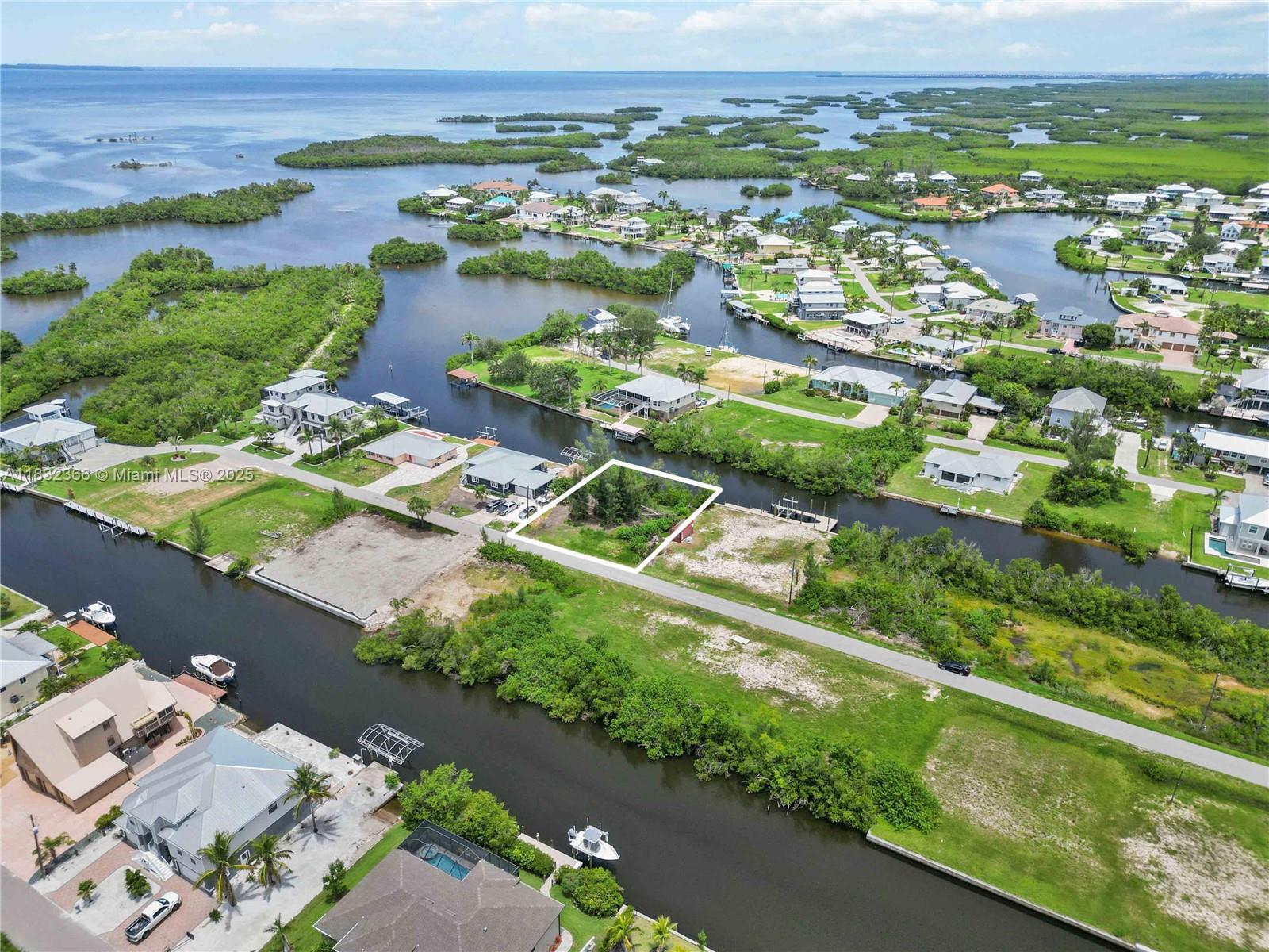 Exceptional opportunity to own a prime waterfront parcel in the highly sought-after Pirate Harbor Community. This residential lot features approximately 100 feet of canal frontage with direct access to Charlotte Harbor and the Gulf of Mexico—an ideal setting for boating enthusiasts and waterfront living. Tucked away on a quiet street with desirable southern exposure, this property offers the perfect canvas to design and build your dream home. With no HOA restrictions and the flexibility to add a private dock, you’ll enjoy a lifestyle defined by freedom, tranquility, and endless water adventures. Located just minutes from downtown Punta Gorda, fine dining, shopping, and major roadways, this rare offering combines natural beauty with exceptional convenience.