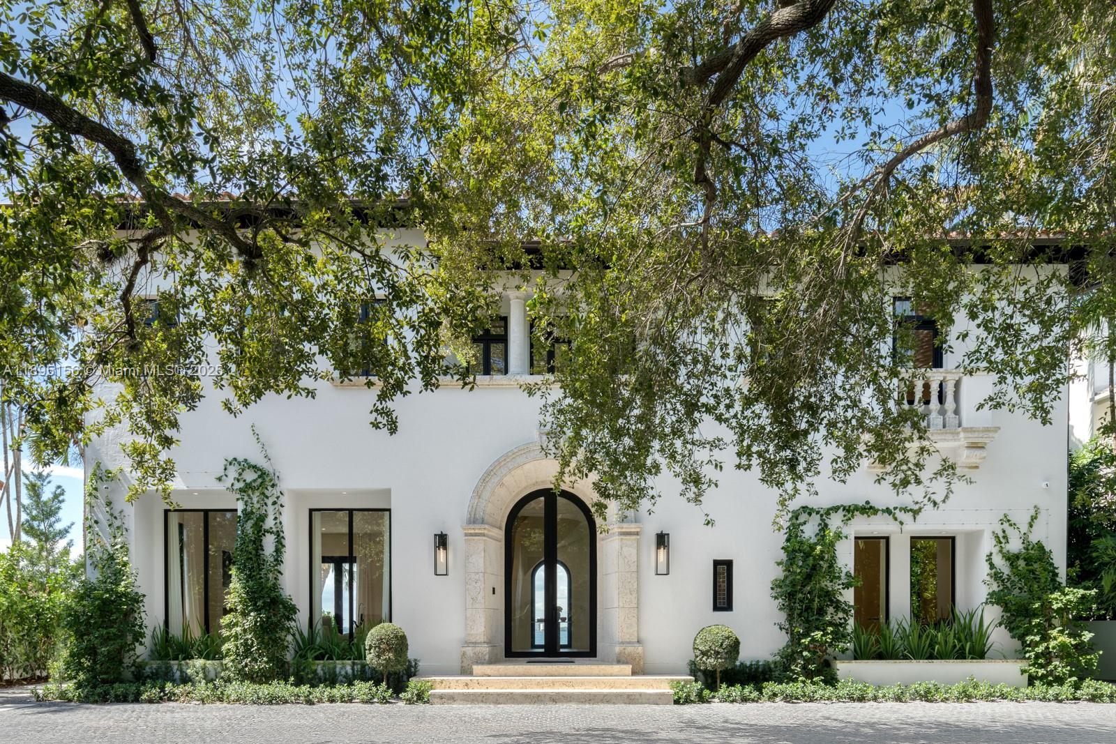 Timeless Architecture Reimagined with Modern Elegance on Iconic N Bay Rd. Developed by Menin Homes & architecture by Zeb Jarosz, this waterfront estate showcases wide open bay & skyline views. Main house offers 4BD/4.5BA while a detached guest residence includes 3BD/3BA with garage. 12’ ceilings, Marmorino plaster walls & wood flooring throughout frames light-filled interiors anchored by a bamboo-flamed travertine fireplace. Bespoke ITALKRAFT kitchen with Sub-Zero & Wolf appliances complements marble-accented baths & custom millwork. Primary suite boasts a steam room, sauna, his & her toilets & terrace with a cold plunge. Enjoy a new pool, jacuzzi, Cocoon shower & custom BBQ. Fully automated Control4 smart home w/ generator, Apparatus lighting & ATRA furnishings complete this masterpiece.
