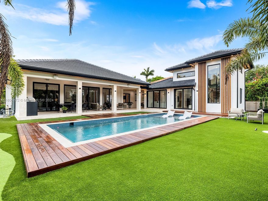 Welcome to this stunning, turnkey contemporary home in Cocoplum. Offering 5 bedrooms and 5.5 bathrooms across 5,391 sqft under AC, this home features high ceilings, recessed lighting, hardwood floors, and floor-to-ceiling windows. The Mia Cucina kitchen, with top-of-the-line appliances, an island, and a pantry, is a chef's delight. There is also a formal dining room, home office, library/den, or media/recreation room. The primary suite has a Mia Cucina walk-in closet and a luxurious marble bathroom with a soaking tub, double shower, and dual vanity. Other bedrooms have custom closets and ensuite bathrooms with elegant finishes. The private yard includes an expansive pool and a summer kitchen, ideal for entertaining. Don’t miss this masterpiece in one of Coral Gables' top neighborhoods!