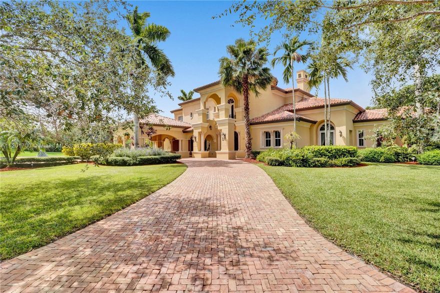 MAGNIFICENT two story estate nestled perfectly in the prestigious Windmill Ranch Estates on a 1.16 acre lake front lot! This Gallagher built custom home has every luxurious detail imaginable. Details include: grand Chicago brick pavered circular drive with oversized porte cochere, stunning foyer entry, soaring ceilings, gorgeous winding staircase, formal living & dining rooms, double sided gas fireplace, billiard room with bar & wine cellar, library/office, chef's delight gourmet kitchen with double islands open to a spacious family room, back staircase, elegant master bedroom suite with sitting area & breathtaking outdoor terrace, all bedrooms are mini suites with their own baths, resort style outdoor patios, summer kitchen, impressive pool with spa, 3 car garage & hurricane impact glass!