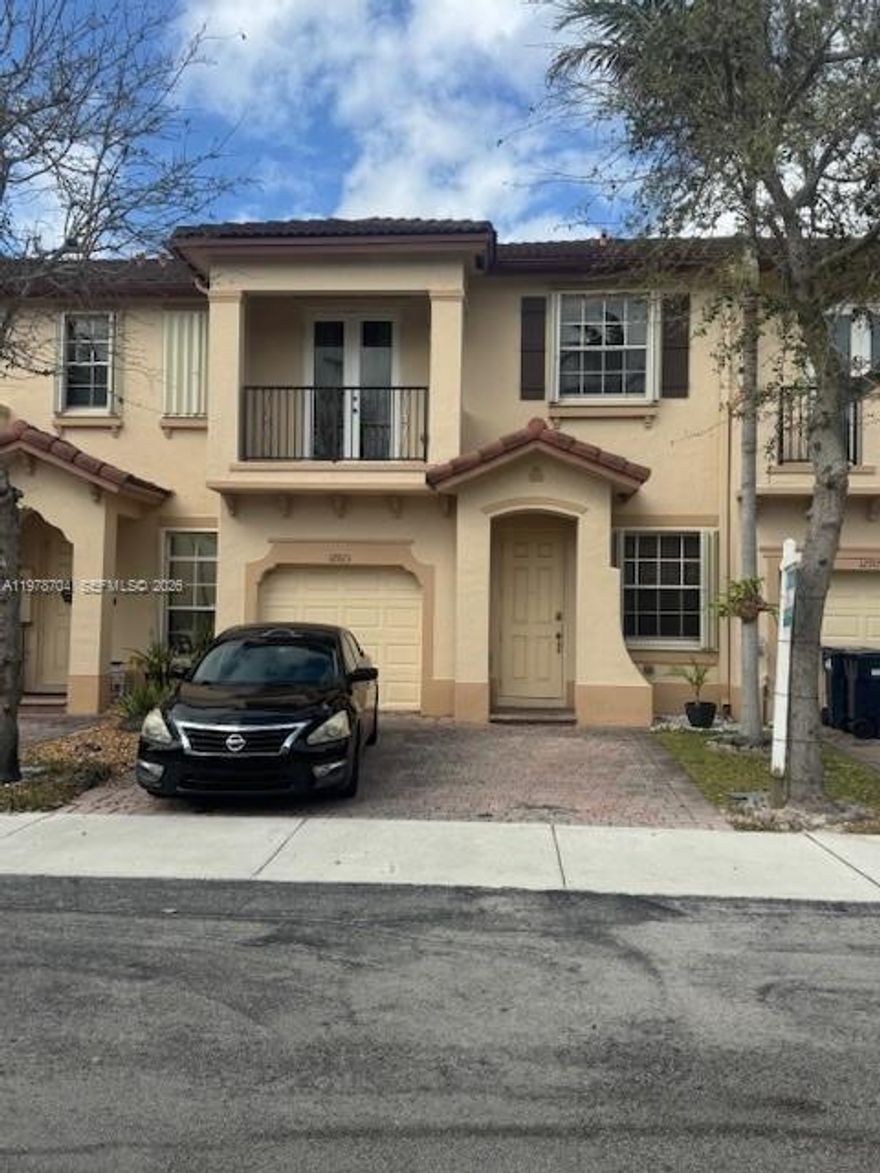 Beautiful 3 bedroom, 2.5-bathroom townhome with a 1 car garage located in the desirable Courts at Tuscany West community in the Tamiami Airport area. This spacious two-story residence features tile flooring throughout the first floor and laminate wood flooring on the stairs and second level. The home offers a partially converted garage, creating a versatile space ideal for a guest room, home office, or exercise room, while still maintaining a Convenient storage area. The primary bathroom has been tastefully renovated, and the kitchen is equipped with stainless steel appliances. Additional upgrades include a new washer and dryer and a new HVAC air handler and compressor.  Step outside to enjoy an ample fenced patio with low-maintenance artificial grass, perfect for relaxing or entertaining. The Courts at Tuscany West community offers a peaceful setting with a clubhouse and a canopy covered mailbox area. The property includes a 2 car driveway, visitor parking directly in front of the home, and additional street parking. Priced to sell, this one will not last!