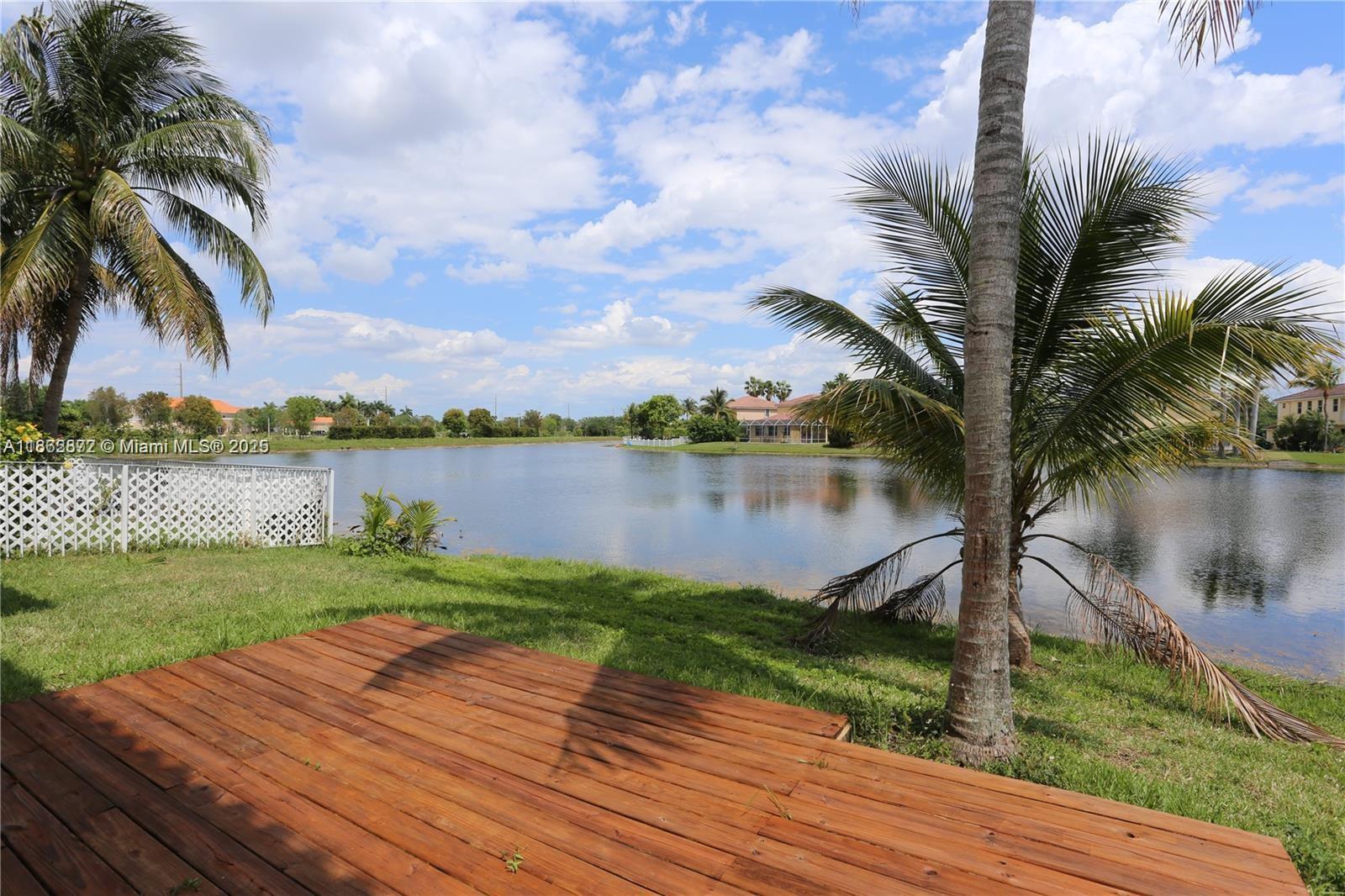 Welcome to your private lakeside retreat! This beautifully maintained 2-story home is perfectly situated on a coveted corner lot, offering unmatched privacy and sweeping water views from nearly every room. Nestled within a prestigious guard-gated community, this residence combines tranquility, security, and style