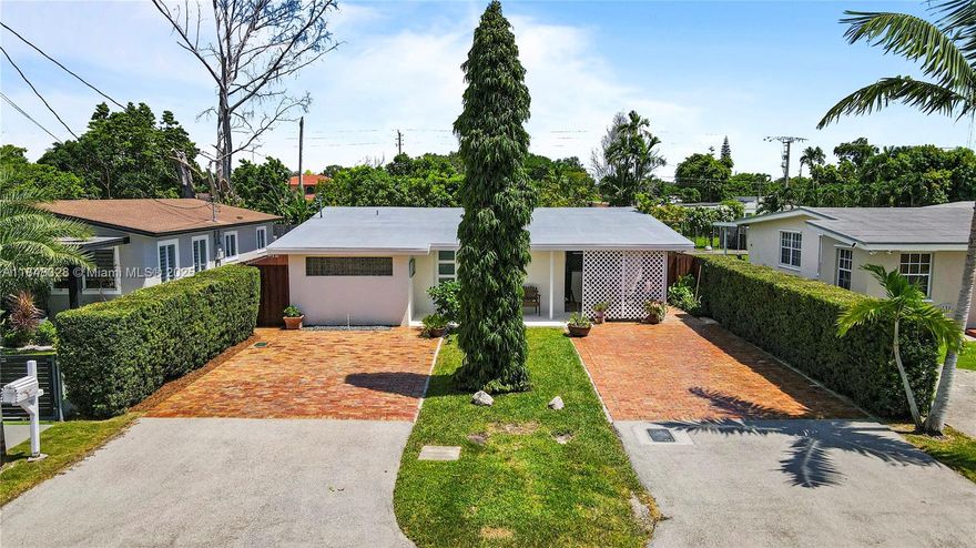 Inviting 3-bedroom, 2-bath home in Coral Villas featuring a spacious family room and open kitchen with updated cabinets and modern appliances. New A/C (July 2025) and impact windows provide comfort and efficiency. Highlights include Bahama shutters, Chicago brick 4-car driveway, and newly tiled front porch. The fully fenced backyard offers a covered patio with insulated roof, mature landscaping, and ample space to relax or entertain. A detached 1-bedroom, 1-bath studio with private entrance and impact windows adds income potential or guest space. Conveniently close to Coral Villas Park, Schenley Park, shopping, and dining.