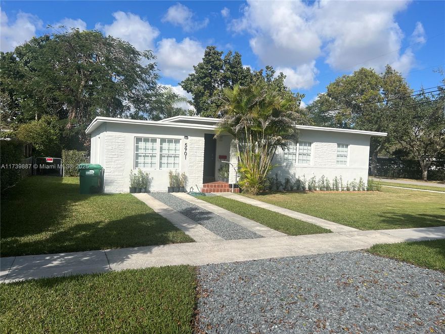 Charming 3-bed, 2-bath home in Riviera Estates. Features a quaint exterior with white facade and brick accents. Modern kitchen with white cabinets, quartz countertops, stainless steel appliances. The spacious living areas are filled with natural light, creating a warm and inviting atmosphere. Large backyard with mature trees. Ideal for peaceful living with easy local access.