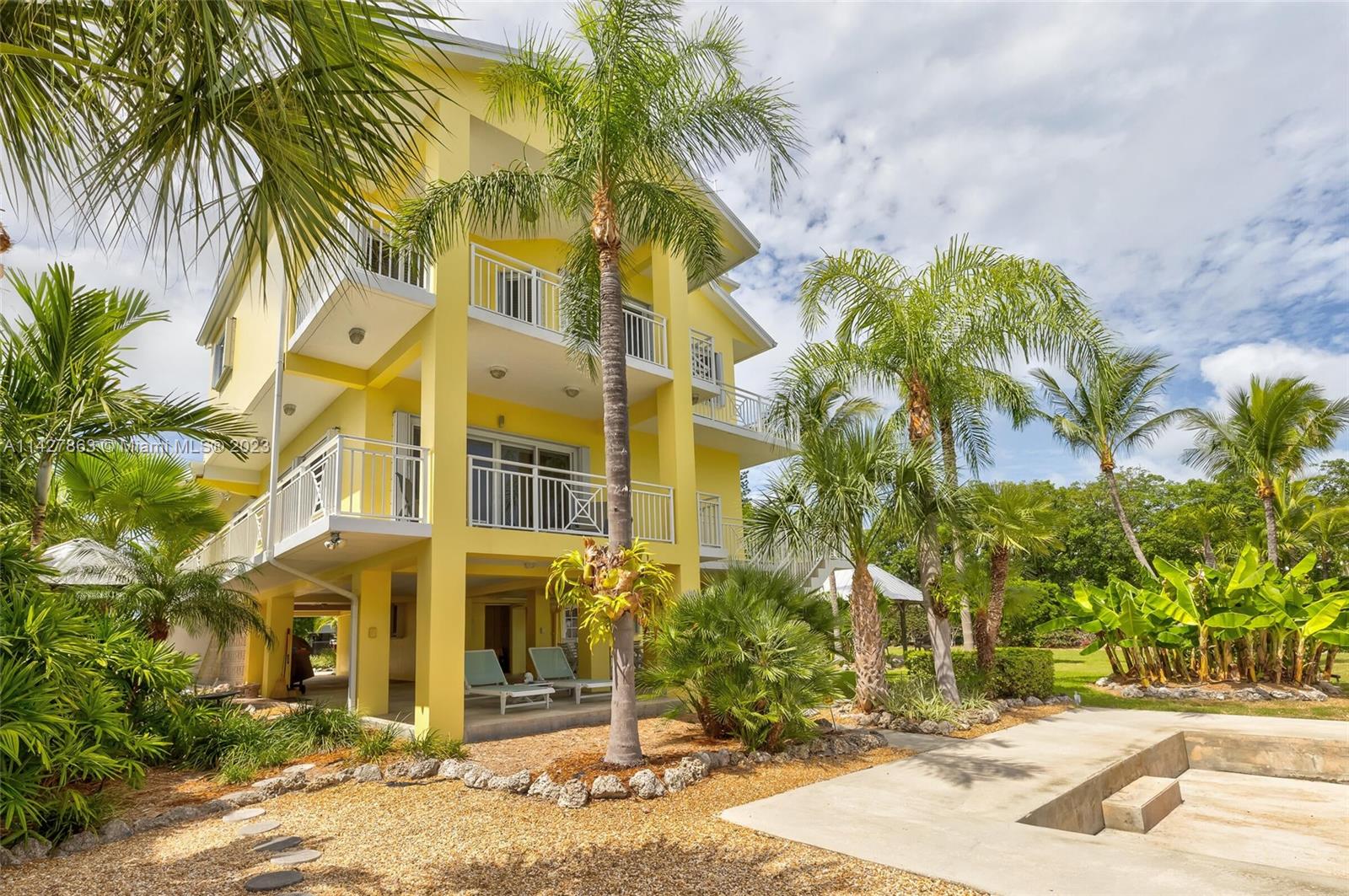 Mini Oceanside Estate with TWO lots! This home and property offer a great opportunity to get the deep water dockage you need and the lovely 4 bedrooms and 4 baths you want., plus an additional lot for double the waterfront. The vacant lot is lushly landscaped and has a separate folio, so you can develop it in the future or keep it as a stunning extension of your outdoor area and water frontage. Enjoy your spacious three-story home that has an open kitchen and living room for great entertaining and gatherings. The third floor is exclusive for you and offers a private suite oasis with a spacious master, bath, balcony, and walk-in closet. You can access the rooftop deck for water views from all around. This solid CBS home has been upgraded with impact windows and doors and is lovingly---