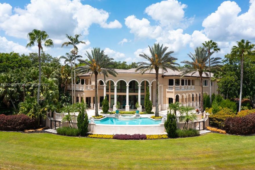 Gorgeous Italian Inspired Estate is now available for you! Hidden away on 1.7 acres and bordered by water on all sides. Marble and granite that are of a sturdy construction and can be found all around the home. The vast grand room has a glass wall that extends from the floor to the ceiling two stories high, guests will have a wonderful look at the waterfall pool that leads down to the extended lake vista. New Gourmet Kitchen equipped with top of the line appliances. A cutting edge Theater, Speakeasy Bar and Art Gallery! The estate also features two Fireplaces, Billiard Room; a Courtyard Entrance with a Koi Pond and Fountain; Putting Greens; Tennis Court; and Outdoor Kitchen. Hurricane impact and an automatic generator are also included. Truly one of a kind property you don't want to miss!