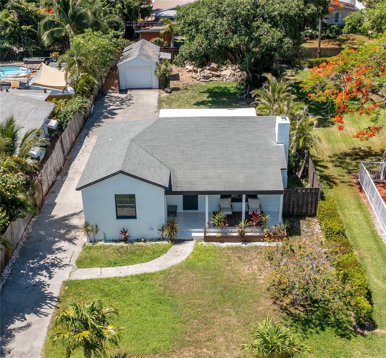 Newly remodeled Delray Beach gem on a 7,500 sq ft corner lot at 246 NE 13th St. Features include a modern kitchen, marble floors, updated bath, stainless steel appliances, and a striking marble fireplace. Rare detached garage, long driveway, and guest parking next to a playground. Spacious patio ready for a Florida room—includes two 8-ft hurricane sliders. Room for pool or addition; $16K credit for impact windows/doors. Walk to Atlantic Ave, Pineapple Grove, and PopStroke. Minutes to the beach. Optional plans for a 3,600 sq ft new build with pool (comps ~$2.8M) available. Move-in ready with major upside!