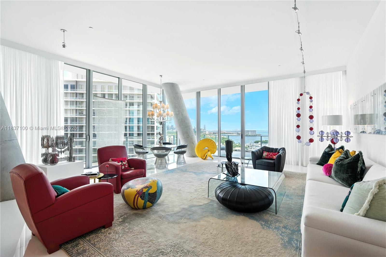 Wake up above the bay, wrapped in 12-foot walls of glass and endless views that steal your breath. Your day begins in a master closet made to rival a designer showroom. Make breakfast at a 30-foot island where light spills across stone and steel. Take meetings in your waterfront office, then relax in wide-open spaces that feel like a true home—not just a condo. Art, air, architecture—every inch of this 4BD residence at Grove at Grand Bay invites you to live boldly, beautifully, and fully. This is not just where you live. This is how you feel.