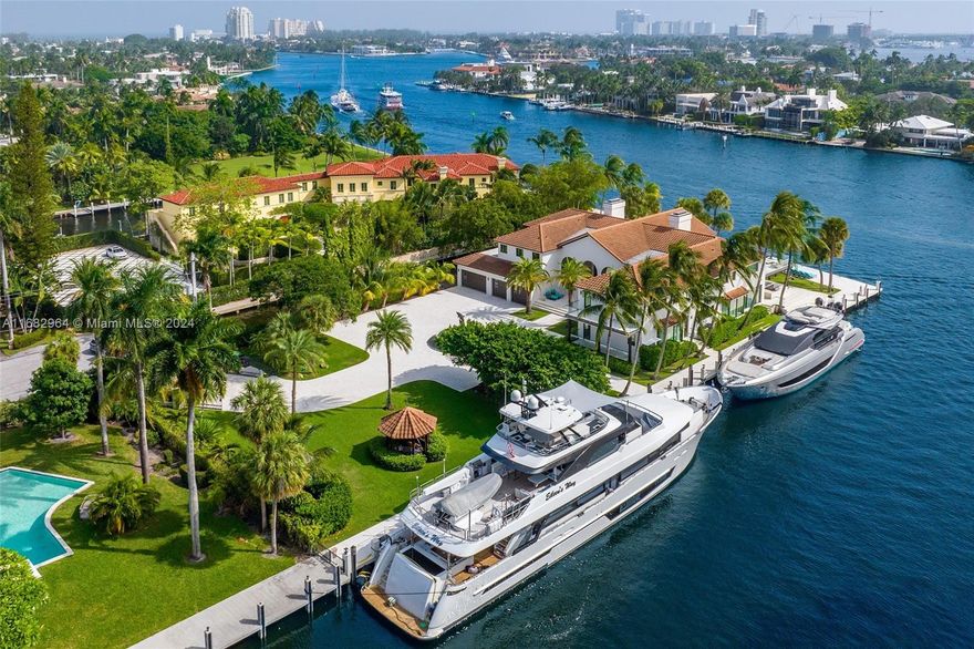Bontona Peninsula stands as a rare jewel on nearly one acre in Las Olas Isles, with ~700 ft of deep-water frontage & spectacular views along the New River. This gated estate spans 10,259 SF, featuring 6 bedrooms, 9 full baths, and a 3,000-SF primary suite with dual closets, a morning bar & a private terrace. Interiors designed by Katia Bates showcase book-matched marble floors, a custom Pecky Cypress entry door & semi-precious stone countertops. The chef’s kitchen, paired with a catering kitchen, is perfect for grand entertaining. Exteriors feature an infinity pool, expansive terraces & dockage for a superyacht with direct ocean access. The estate delivers privacy, luxury & breathtaking views, with great proximity to top schools, private airports & FLL International Airport.