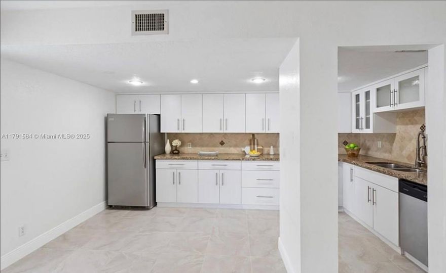 Step into this beautifully remodeled 3-bedroom, 2.5-bath condo offering modern living at its finest. The open-concept layout features stylish finishes, an updated kitchen, and a spacious primary suite with a sleek, private bath. Enjoy year-round comfort with central heating and cooling. Relax or entertain in your private backyard oasis, complete with low-maintenance turf. Impact windows throughout. This first-floor unit includes assigned parking and access to a clubhouse. Pet-friendly community and low monthly HOA. A perfect blend of comfort, style, and convenience!