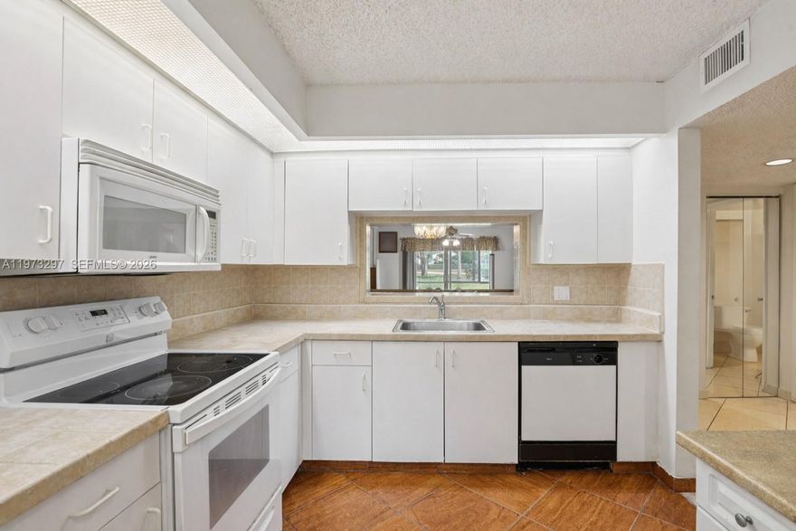 Welcome to this inviting FIRST-FLOOR 1 bedroom, 1.5 bath condo nestled in one of Pembroke Pines’ most sought-after gated communities. You can rent within first year of ownership and at least one buyer has to be 55 or older. From the moment you step inside, you’ll appreciate the comfortable layout that flows seamlessly from the open living and dining area into a spacious bedroom retreat with generous closet space and a private bath. The additional half bath offers added convenience for guests, making everyday living both practical and welcoming. First-floor access provides ease and peace of mind, whether you’re bringing in groceries or simply heading out for a morning stroll. Imagine starting your day with coffee and fresh air, enjoying the calm surroundings and the relaxed South Florida lifestyle right outside your door. Beyond the residence, the community offers an exceptional resort-style experience with a grand clubhouse, fitness center, sparkling pools, tennis and pickleball courts, golf, walking paths, courtesy transportation, and a vibrant calendar of social activities. Guard-gated with 24/7 security, it’s a setting designed for comfort and connection. Ideally located near shopping, dining, medical facilities, and major highways, everything you need is within easy reach. Whether you’re searching for a full-time home or a seasonal escape, this residence offers the perfect opportunity to create your own peaceful retreat in the heart of Pembroke Pines.