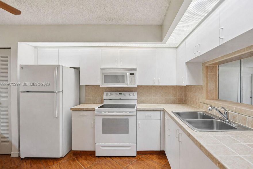 Welcome to this inviting FIRST-FLOOR 1 bedroom, 1.5 bath condo nestled in one of Pembroke Pines’ most sought-after gated communities. You can rent within first year of ownership and at least one buyer has to be 55 or older. From the moment you step inside, you’ll appreciate the comfortable layout that flows seamlessly from the open living and dining area into a spacious bedroom retreat with generous closet space and a private bath. The additional half bath offers added convenience for guests, making everyday living both practical and welcoming. First-floor access provides ease and peace of mind, whether you’re bringing in groceries or simply heading out for a morning stroll. Imagine starting your day with coffee and fresh air, enjoying the calm surroundings and the relaxed South Florida lifestyle right outside your door. Beyond the residence, the community offers an exceptional resort-style experience with a grand clubhouse, fitness center, sparkling pools, tennis and pickleball courts, golf, walking paths, courtesy transportation, and a vibrant calendar of social activities. Guard-gated with 24/7 security, it’s a setting designed for comfort and connection. Ideally located near shopping, dining, medical facilities, and major highways, everything you need is within easy reach. Whether you’re searching for a full-time home or a seasonal escape, this residence offers the perfect opportunity to create your own peaceful retreat in the heart of Pembroke Pines.