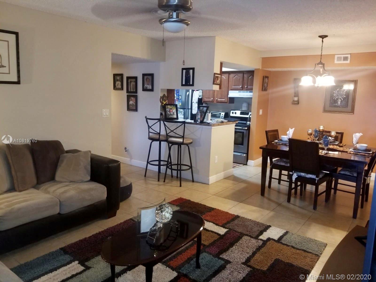 Come and see this spacious 2 bedroom, 2 bathroom! Split floor plan, full size washer and dryer in unit. Very nice and well maintained. Tile flooring in entry, kitchen, bathrooms, living and dining areas. Laminate flooring in bedrooms. Gated community. Amenities include: Pool, tennis court, volleyball, court, barbecue area, fitness center, car wash area and much more.