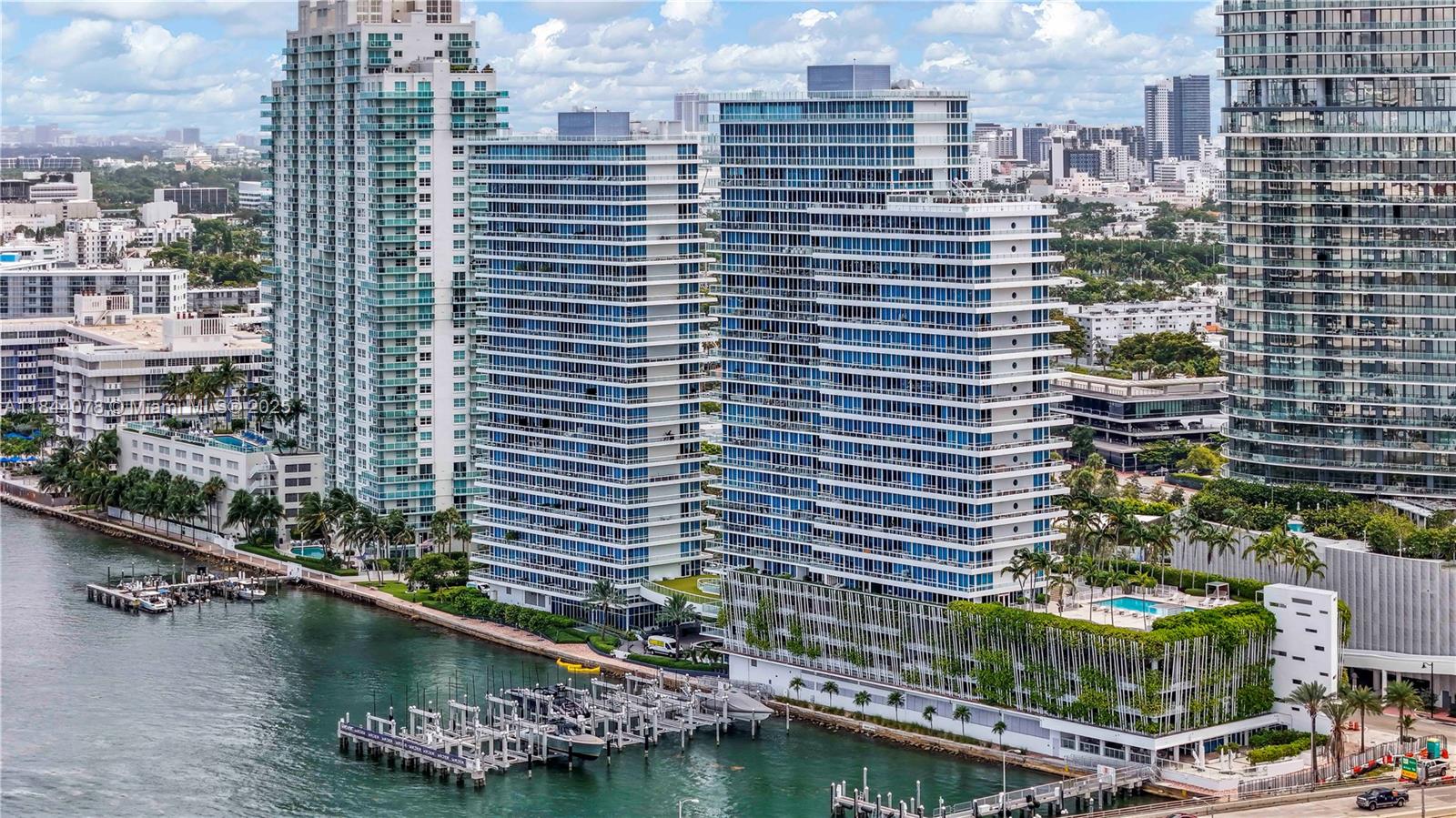 Pay for the view!!! Stunning corner flow-through unit 2B/2B with 1,210 SF + wraparound balcony offering breathtaking bay, ocean, and city views. Enjoy sunrise & sunset from every room! Fully remodeled with marble & wood floors, Sub-Zero & Gaggenau appliances , Dekton countertops, wine cooler, electric shades. Floor-to-ceiling windows flood the space with light. Primary bath with jacuzzi. Valet parking included. Impeccably maintained by owner, ideal as a primary residence, investment or second home. Resort-style amenities: 2 jacuzzis, pool, cabanas, sauna, steam room & cold plunge. Walk to the beach, Lincoln Rd, top restaurants & nightlife. Exclusive neighbors : Star Island in front, Five Park behind. Live the best of Miami lifestyle!