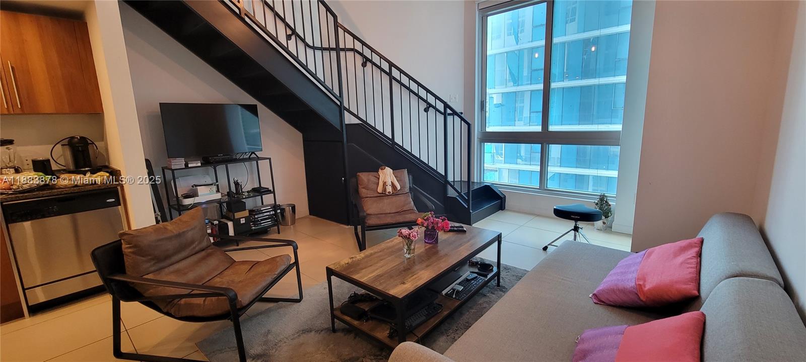 COZY LOFT 1/1.5 in the pulsating heart of downtown Miami - close enough to walk over the Brickell bridge, to Bayfront Park, ocean walk, and all the restaurants, lounges, and shops you need. Facing south towards Biscayne Blvd, the luxury Aston Martin condo, and a view of the Miami River leading out to Biscayne Bay from the balcony. Guest bathroom located downstairs, with a spacious living room, in-unit washer/dryer, and upstairs bedroom with its own bathroom and walk-in closet. Unit is located at the END of the hallway set back for extra privacy. Comes with 1 assigned parking spot in the attached garage. Building has a gym with beautiful views, meeting & events spaces, kid's playroom, pilates/yoga room, and more. The pool deck is currently undergoing a renovation. HOA is $991/m.