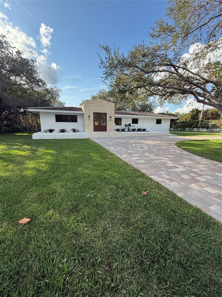 Completely renovated modern estate on an expansive corner lot in desirable Pinecrest. Stripped to the shell and rebuilt, Fully reimagined and Reconstructed from the inside out, Every detail is brand-new including electrical, plumbing, roof and impact windows and doors throughout. 3862sqft living area, as per recent appraisal. This home blends modern luxury with warm natural finishes, offering an elegant, open-concept design throughout. This stunning 5 bedrooms and 4 bath home features a spacious open floor plan with vaulted ceilings, natural finishes, and abundant light throughout. The designer kitchen offers custom wood cabinetry, premium stone counters, an oversized waterfall island, induction cooktop, double oven, and full wall of pantry storage. The open layout flows into a bright and oversized family/dining/living space, perfect for entertaining. The primary suite includes a luxurious spa-style bathroom with double vanity, freestanding tub, and large glass-enclosed shower. 48x48 porcelain flooring throughout the main living areas, and beautiful natural wood flooring in all bedrooms. Additional flexible rooms are perfect for office, gym or playroom.
Enjoy the oversized covered terrace with wood ceiling and modern fans, Newly built pool with safety net, and a spacious backyard surrounded by mature trees for privacy. Long paver driveway with ample parking. Beautifully remodeled and move-in ready, located in one of Pinecrest’s most sought-after neighborhoods.
