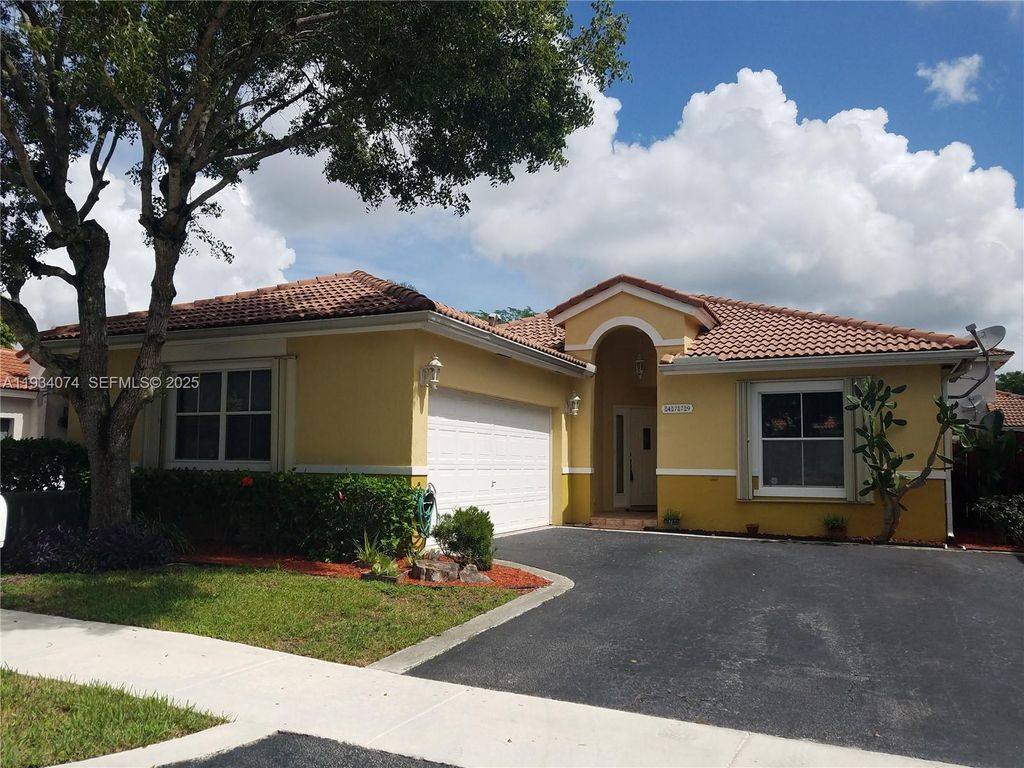 Photo of 4779 NW 5th Ct, Coconut Creek, FL 33063 (MLS # A11934074)