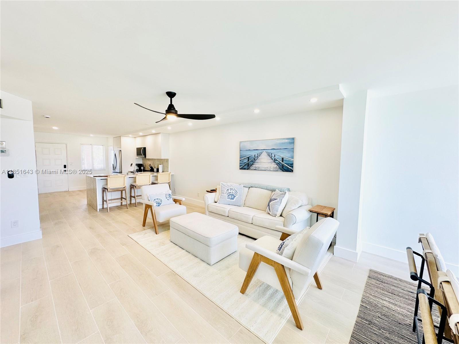 Beautifully renovated condo, a short walk to the beach and the heated pool! All NEW flooring, bathroom tile and fixtures, kitchen and bathroom cabinetry, countertop, appliances, furnishings, and more! Available for season and off-season months. This unit is located on the second floor with an elevator or stairway, only a couple steps from the door. This lovely condo accommodates six guests featuring two bedrooms, each with king beds (one bedroom can be set up with twin beds instead, upon request) and a living room sofa that pulls out to a queen bed. Enjoy an open concept with a brand new kitchen, living area with a smart TV and electric fireplace beneath it, and dining overlooking Jupiter Bay's tranquil lake.