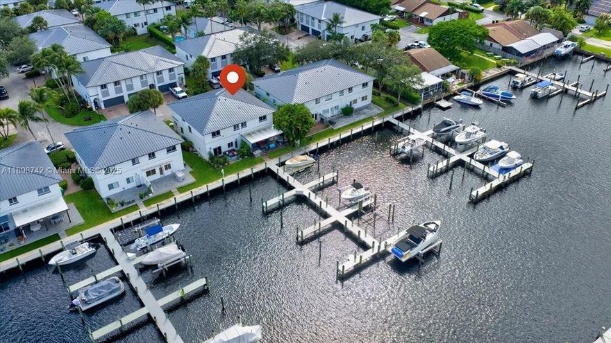 Boater's paradise! 2017 build with Brand New Metal Roof and 20,000 lb boat lift. A rare opportunity, this townhome is ONE of Ten residences in this Exclusive gated community with Ocean Access and a Private Marina with a private Dock right in your backyard! No Expense spared featuring all Developer Upgrades plus a Full Interior Renovation completed this year with Top-of-the-line Finishes and a New AC unit. Enjoy outdoor living on your Private covered terrace with a built-in BBQ, overlooking the serene waterfront and protected nature reserve. Prime location just minutes from the airport, Hard Rock Casino, I-95, and the Turnpike. Cruise down the River to nearby waterfront restaurants, with Downtown just 15 minutes away by boat and the Intracoastal only 30 minutes out.