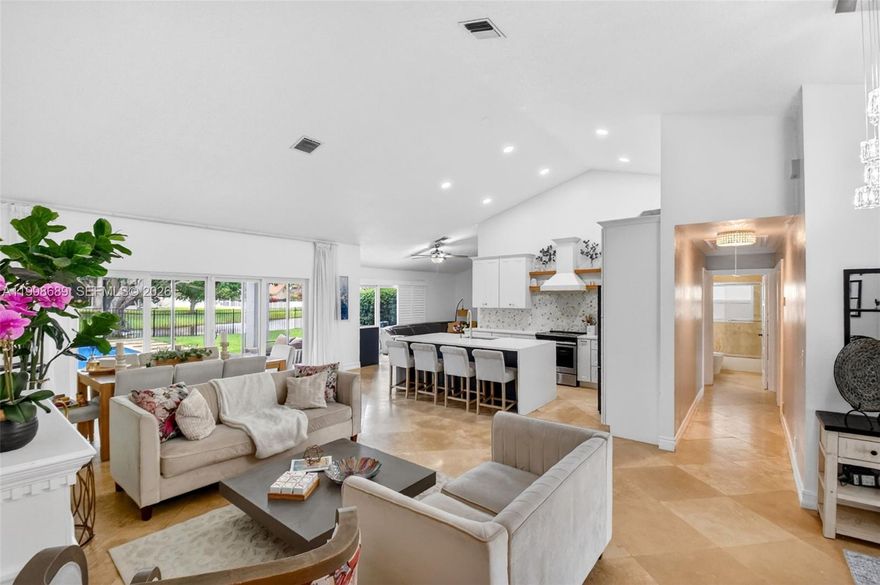 1ST MONTH FREE! Beautifully renovated lakefront pool home in the highly desirable Sun Valley community. This spacious residence features 3 bedrooms + den/office (optional 4th bedroom), 2 bathrooms, and a bright open-concept layout with vaulted ceilings and abundant natural light. The modern kitchen is designed for both everyday living and entertaining, featuring a large island with seating, custom cabinetry, and seamless flow into the living and dining areas. Multiple living spaces, including a formal living room and family room, provide flexibility for relaxing or hosting. The primary suite offers a walk-in closet and direct access to the backyard retreat. Step outside to a covered lanai and expansive travertine patio overlooking a heated saltwater pool and spa with tranquil lake views—perfect for sunset evenings, entertaining, or family time. The fully fenced yard adds privacy and space for outdoor enjoyment. Additional features include impact windows and doors, plantation shutters, custom closets throughout, dual-zone A/C, central vacuum, full-size washer/dryer, and a finished garage flex space ideal for a gym, game room, or workspace. Lawn and pool maintenance included. Available furnished or unfurnished (furniture also available for purchase). Prime location with access to community amenities including tennis, pickleball, and more—just minutes from shopping, dining, and major highways.