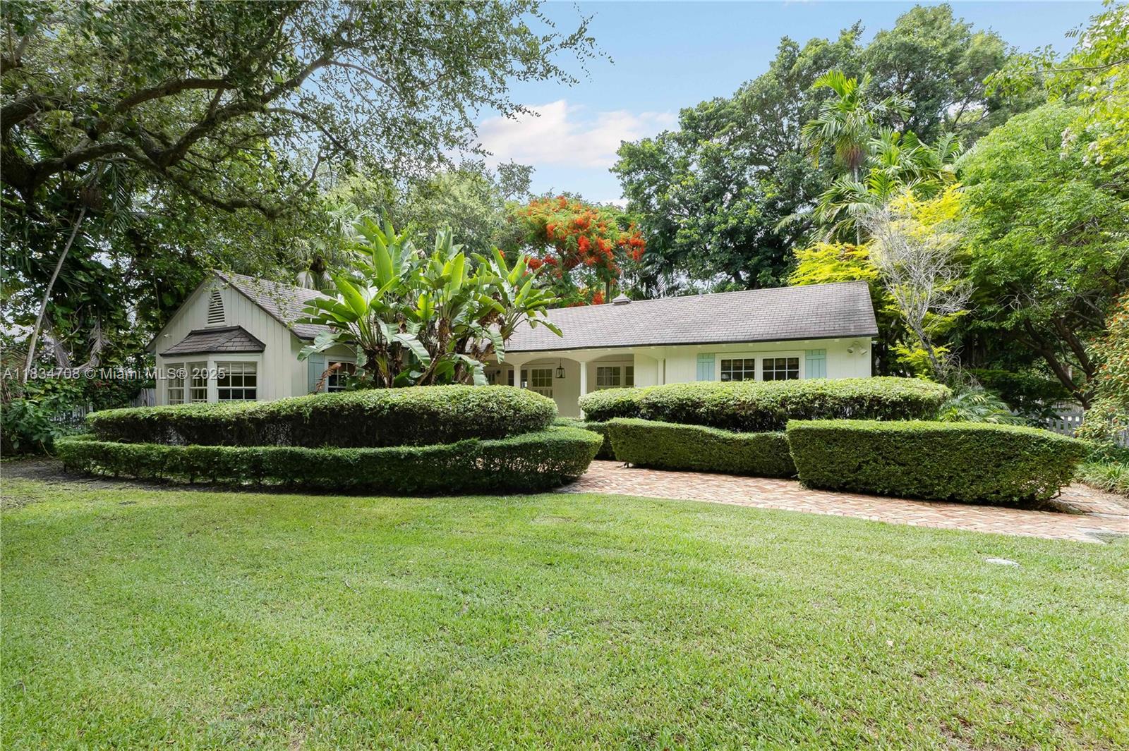Beautiful cottage-style home in charming South Coconut Grove features 3 bedrooms, 2.5 bathrooms, original oak hardwood floors throughout, ample inviting living spaces, cozy original wood-burning fireplace, and bright bay windows flooding the home with natural light. Outside, enjoy the heated pool surrounded by natural coral rock patios, spacious covered porch perfect for entertaining and a white picket fence enclosing the picturesque front yard. Nestled in one of Miami's most coveted neighborhoods, walking distance to top-rated schools, shopping, parks, UM, with easy access to downtown Miami and Biscayne Bay. Perfect blend of timeless Grove character and modern comfort. Flexible rental terms available!