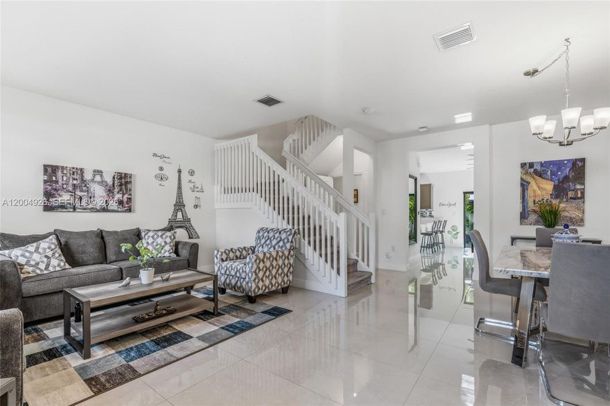 Welcome to this peaceful villa within the resort-style Aquabella community. This 3-bed, 2.5-bath smart-home residence stands out with its immaculate, move-in-ready condition, bright open layout, and imported Spanish porcelain flooring throughout the first floor. The kitchen is polished, practical, and spacious, with stainless steel appliances, a large sink, generous counter space, and an easy flow into the living area. The real highlight is the private tropical patio with a covered gazebo–an outdoor space that feels calm, private, thoughtfully designed, and hard to find. Upstairs offers comfortable bedrooms, washer and dryer, plus a newer HVAC system and enhanced insulation. Close to highways, shopping, and dining.