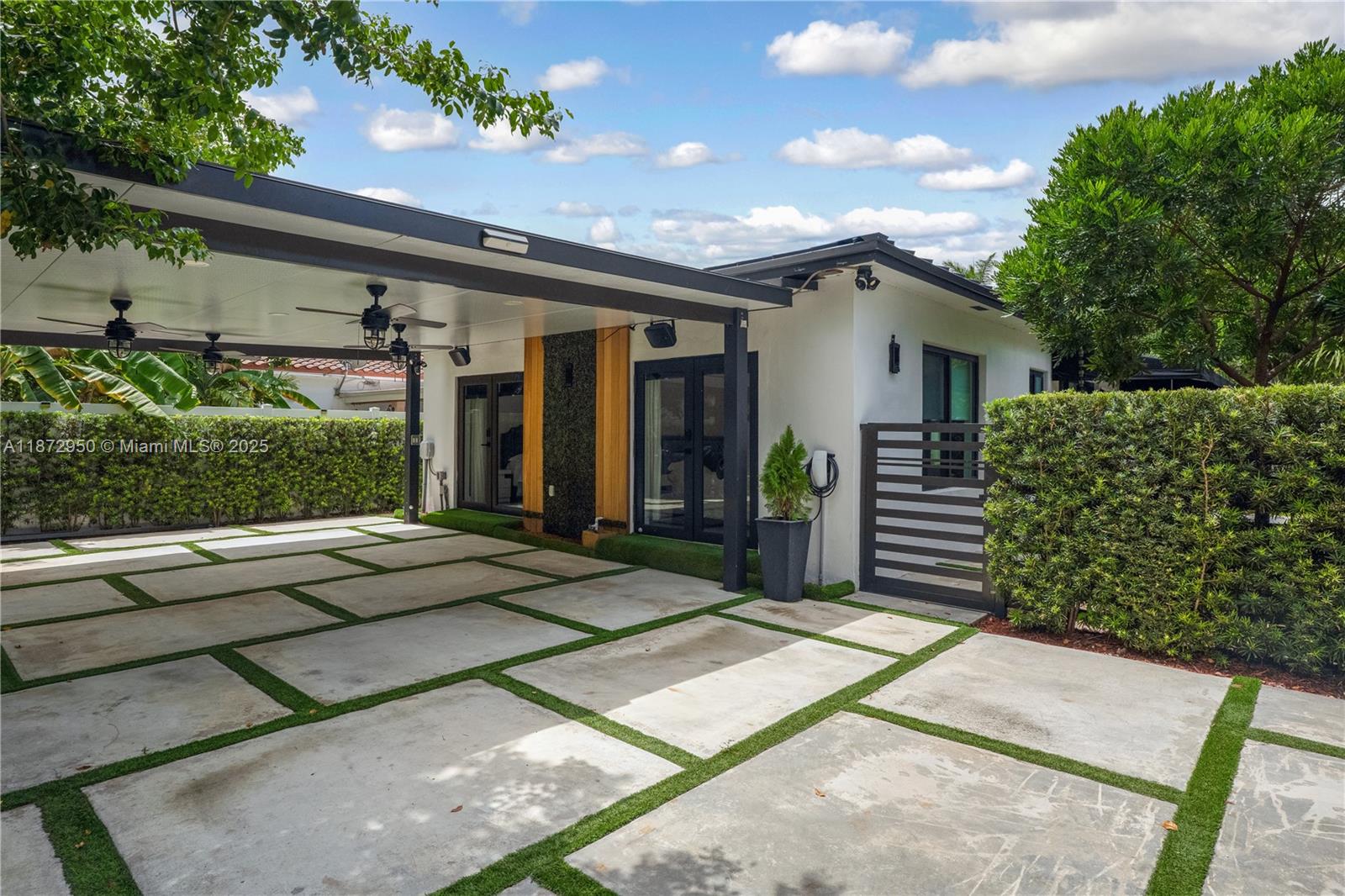 Stunning fully renovated 3BR/3BA plus master den home near all vibrant areas in Miami and featuring luxury finishes throughout! Enjoy modern security with automated fingerprint/combination entry doors, Ring alarm, and full video surveillance. Home upgrades include a new roof '24, new 5-ton A/C '25, impact windows/doors, and a beautifully renovated kitchen with top-of-the-line appliances. Spacious living room with built-in theater system, elegant tile/stone finishes, and Toto washlets bathrooms with showers & jacuzzi tub. Master suite with den opens to a private yard with a luxurious pergola. Outdoor highlights include a large carport, expansive side yard, 2 oversized storage areas, and gorgeous landscaping. Truly Move-in ready with every detail designed for comfort, style, and security!