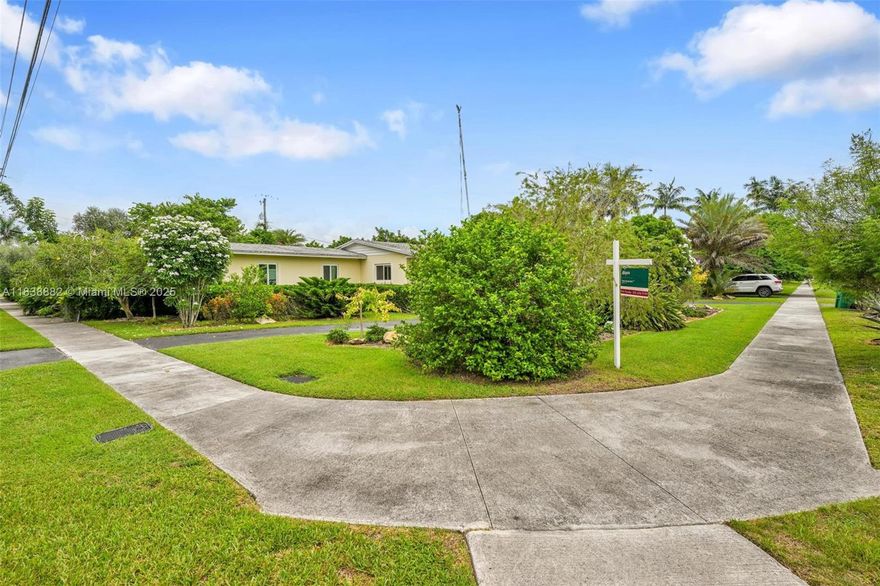 Double the charm, double the opportunity! This gem is essentially two homes in one—a 4/2 split into a vintage main residence and an updated 2/1 guest house, each with its own entrance, parking, connected by a hallway. Situated on a spacious 20,725 sq ft corner lot just a block off Krome Ave. Recent upgrades include a 2018 roof, UV-tinted impact windows (2021), energy-efficient water heaters (2024), and new A/C (2021). The main home is a nostalgic nod to 1963 with a formal living room, den, dining, laundry, and large workshop. The guest house is move-in ready—perfect for family, rental, or visitors who won’t overstay their welcome. Outside, your own edible paradise awaits with lychee, Meyer lemon, guava, olive, tamarind, cinnamon, and more. Brimming with character, potential, and produce!