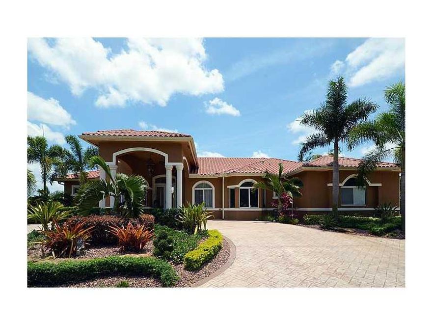BEAUTIFUL CUSTOM BUILT GATED 4 BEDROOM 4.5 BATH HOME, HUGE GAME ROOM AND OFFICE/DEN ROOM ON 1.2 ACRES. HUGE KITCHEN W/SS APPLIANCES, WATER TREATMENT SYSTEM FOR ENTIRE HOUSE. MARBLE FLOORS THROUGHOUT, WOOD FLOORING IN MASTER BEDROOM SUITE.    POOL AREA HAS  AN OUTSIDE KITCHEN,BAR AND A FULL BATHROOM. PROPERTY WAS BUILT IN A ELEVATED GROUND AVOIDING FLOODING,IMPACT WINDOWS ALL THROUGHOUT, PLANTATION SHUTERS, AND CALIFORNIA CLOSETS,YARD WITH PLAY GROUND AREA, NEW AC MANY EXTRAS TO LIST.THIS IS A "MUST SEE".