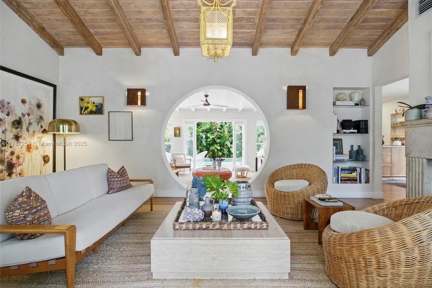 Effortless elegance in Belle Meade.This 4-bedroom pool home--plus garage--on a large lot has been meticulously renovated by Anastasia Koutsioukis, the co-founder and creative visionary behind Miami's beloved Mandolin Bistro. Interiors showcase impact windows, original wood floors and striking architectural details. Living area features a carved stone fireplace and vaulted ceiling. A keyhole-shaped archway frames a stunning view from the front door to the pool. Primary suite boasts corner windows, generous closets and ensuite bath with rainfall shower. Lush outdoor space with dining pergola and summer kitchen blends Miami tropical modern and Mediterranean chic. Belle Meade is a gated bayfront community known for quiet tree-lined streets. Create lasting memories in this extraordinary home!