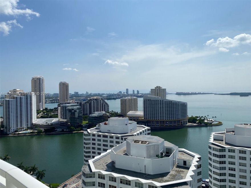 Summer Waterfront Escape. Stunning Furnished Seasonal Rental Available for Summer Months (3 MONTHS MINIMUM). Enjoy the ultimate warm weather retreat in this beautifully furnished 2BD / 2.5BA waterfront condo featuring breathtaking water views from every room and spectacular sunrise to sunset scenery from the expansive wraparound balcony. Floor to ceiling windows fill the residence with natural light, while the open concept living and dining areas create the perfect space for entertaining or relaxing all summer long. The pristine kitchen offers generous counter and storage space, complemented by a spacious primary suite with a spa inspired bathroom and walk in closet. The second bedroom also features its own walk in closet, ideal for guests or a home office. Powder room and in unit washer/dryer included. Experience luxury waterfront living with resort style comfort and unforgettable views all summer season. Walk to the best restaurants and stores in Brickell.