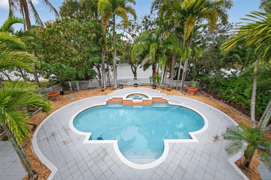 Introducing a beautifully appointed LAKEFRONT estate home with pool that blends timeless sophistication with modern refinement. This elegant 4-bedroom, 2.5-bath residence PLUS loft offers gracious living spaces accented by designer finishes and exceptional architectural detail. A highlight of the home is the private balcony from the upstairs bedroom, capturing sweeping lake views and enhancing its estate-like allure.  The residence showcases inset MARBLE flooring, custom lighting, upscale window treatments, and a series of tasteful upgrades throughout. The gourmet granite kitchen features premium cabinetry and a charming breakfast nook overlooking the home’s lush, tropically landscaped grounds.  Outdoors, enjoy a serene lakeside setting with a covered terrace, salt-treated resort-style pool with advanced heat pump controlled by WIFI system.  Perfectly positioned in a sought-after location, this refined estate sits moments from the Miramar Tennis Complex, excellent schools, parks, dining, and everyday conveniences—offering an exceptional lifestyle in one of the area’s most desirable communities.