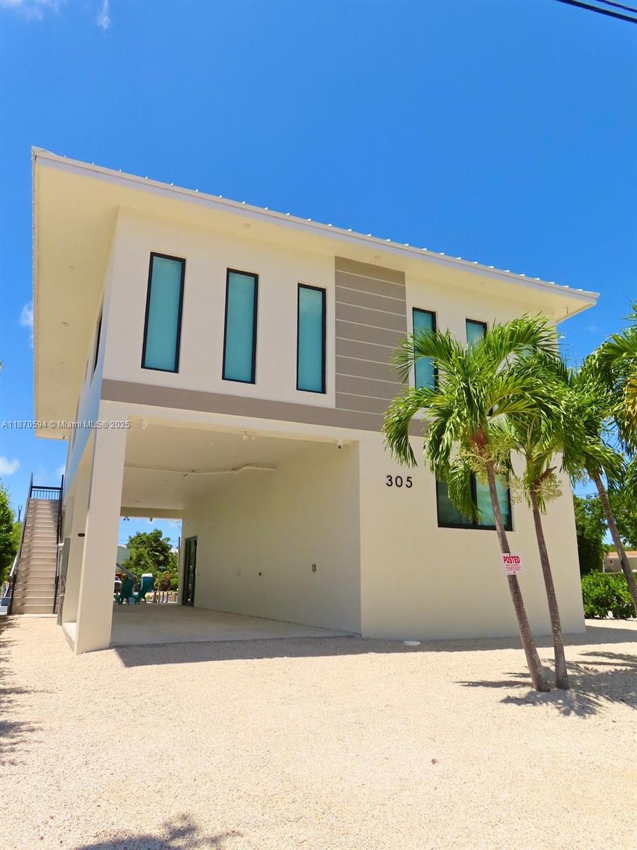 This complete modern home brings together luxury, comfort, and true spirit of the Keys. With soaring high ceilings, an open concept kitchen, and fully furnished interiors, every detail is ready for you to move right in.
Step outside to your 30 foot dock, perfect for your boat and endless days on the water. From here, you're just minutes away from the sandbars, world class and unforgettable sunsets.