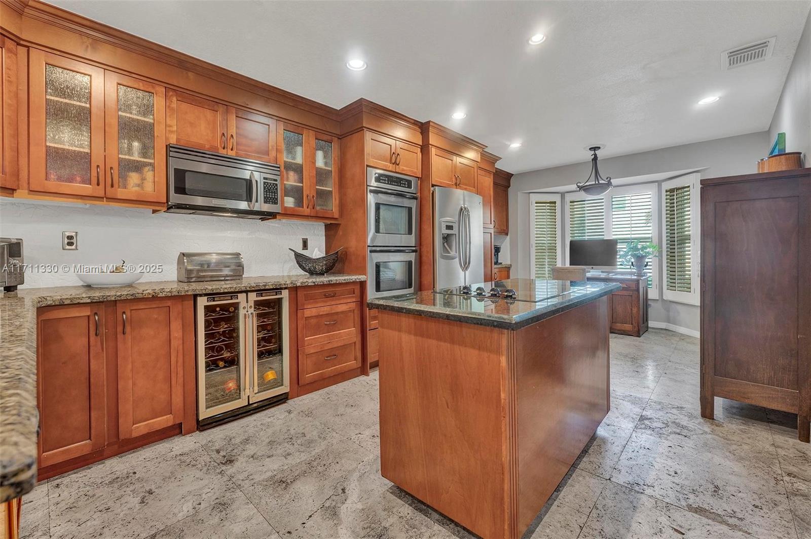Elegant 3BR/2.5BR Corner Lot Home in Gated West Lake Village, Live just minutes from Hollywood Beach, in this beautifully upgraded home W/ 2-car garage in one of Hollywood's most desirable gated communities. Highlights include soaring ceilings, marble floors, a designer kitchen W/ granite counters & double ovens & a custom-built den. Upstairs offers a spacious primary suite with spa-style bath & XL closet W/ built-ins. Enjoy outdoor living in a private, zen-inspired backyard W/ paver patio & custom teak-stained privacy fence. Impact windows, new A/C W/ sterilization system, fresh exterior paint & designer finishes throughout. West Lake Village features 24/7 security, a resort-style pool, tennis & pickleball courts, gym, clubhouse, all just minutes from downtown Hollywood & FLL Airport.