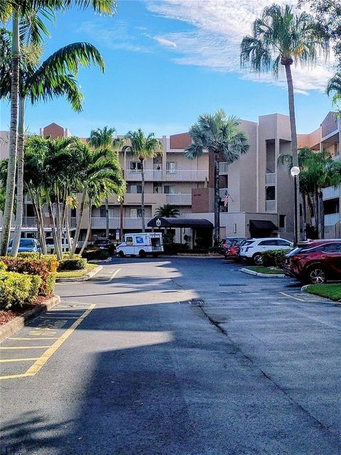 Photo of 7557 Granville Dr #305, Tamarac, FL 33321 (MLS # A11927303)