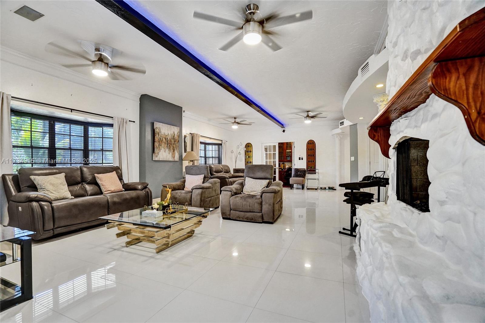 Discover an expansive 7,000+ sq ft Davie estate designed for multi-generational living—basically 2 homes for the price of one! Offering 7 beds, 6.5 baths, 2 full kitchens, and 5 fireplaces, this remarkable property sits on nearly an acre with a gated entrance. Relax by the pool, enjoy the tennis court, and embrace the privacy. Across the street a new luxury development promises rising values, making this an exceptional investment. Generous, versatile living spaces open to endless possibilities, from cozy nights by the fireplace to unforgettable gatherings. Located just off Griffin Rd with easy access to I-75 and the Turnpike. Whether you’re looking for an ideal setup for extended family or a spacious retreat, this home is brimming with potential and possibilities for the discerning buyer.