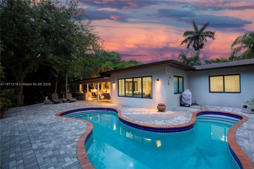 Beautiful 3-bedroom, 2-bath Canal front home near Dante Fascell park and South Miami. The setting for this split plan home is an oversized lot on a quiet and lush corner, with a large covered patio with summer kitchen and free form pool that are great for entertaining or just relaxing. The home has an updated, open plan kitchen and stunning wood floors throughout. Large updated Master Bathroom with a spectacular walk in closet and cabana door to the pool. Circular driveway and indoor laundry. Impact windows and doors. This peaceful retreat will not last on the market, it should be at the top of your list.