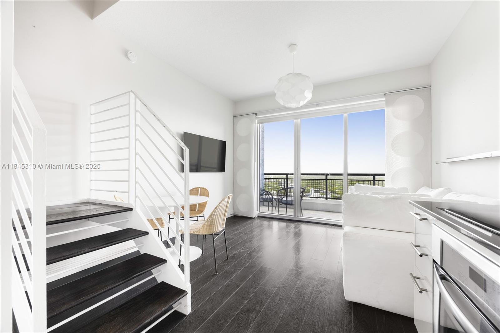 Modern two-story loft in the heart of Brickell, fully furnished and flooded with natural light. Enjoy stunning sunset views from two private balconies and a spacious open layout with volume ceilings and full roller shades. The sleek kitchen flows into a bright living area, while the upstairs primary suite features ample storage and an en-suite bath. In-unit washer/dryer, covered garage parking, and resort-style amenities including a pool and fitness center.