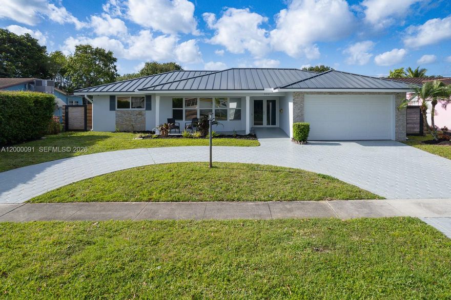 Beautifully updated 4-bedroom, 3-bath single-story home offering 2,288 SF of move-in ready living in a quiet, desirable neighborhood just 5 miles from the beach. This home features a circular driveway, 2-car garage, and a 2021 metal roof with 2023 central air for peace of mind. Inside, enjoy a bright open-concept floor plan with rich wood floors, recessed lighting, and a spacious living area filled with natural light. The upgraded kitchen boasts granite countertops, stainless steel appliances, and a snack-bar counter perfect for entertaining. A formal dining room adds elegance, while two master suites provide flexible living options. Additional highlights include impact windows, plantation shutters, zebra blinds, and ample storage. Step outside to a 350 SF screened-in patio with travertine floors plus an additional open patio—ideal for relaxing or hosting. Conveniently located near top-rated schools, hospital, and just 7 miles to Fort Lauderdale-Hollywood International Airport.