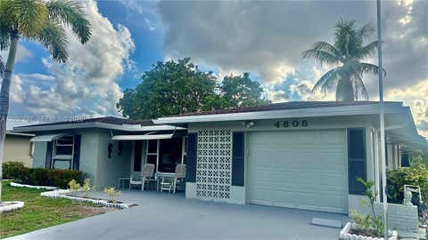 Photo of 4805 NW 49th Rd, Tamarac, FL 33319 (MLS # A12030797)