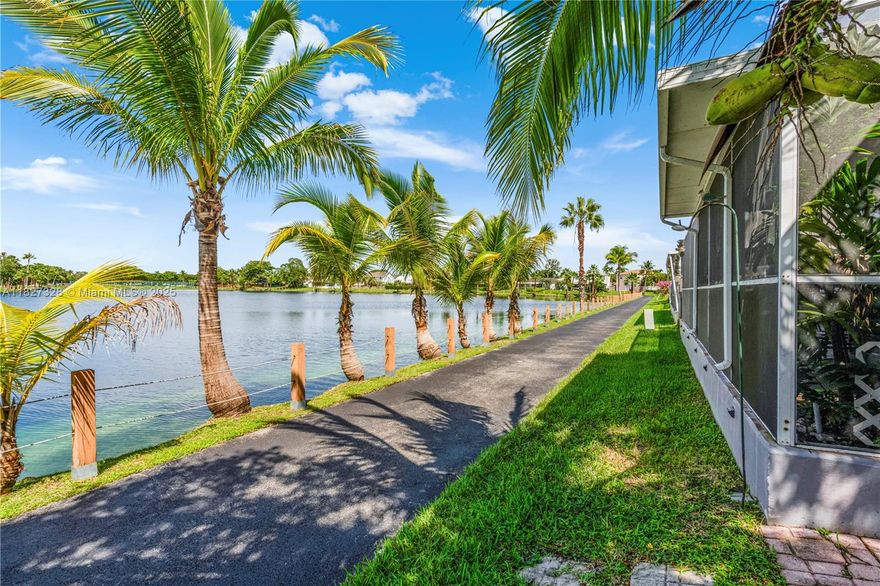 Low maintenance living with expansive lake views! This updated Cutler Bay home offers a new kitchen, new vinyl plank flooring, and a spacious additional room—perfect for a home office. Enjoy indoor-outdoor living with a large screened-in patio overlooking the lake, with stunning sunrise and sunset views. Generously sized bedrooms, updated baths, fresh interior and exterior paint, and a five-year-old roof add to the appeal. New impact garage door. Walking trails, community pool, lawn care included in HOA. Located near the new Publix, Baptist Urgent Care, restaurants, parks, schools, and shopping. Minutes to FL Turnpike, Black Point Marina, walking/biking paths. Golf cart friendly town! Owners Flood policy can be assumed by new owner to save on policy premium.