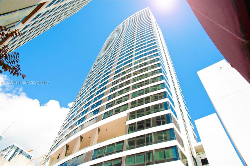 CRYPTOCURRENCY ACCEPTED! Turnkey, fully furnished studio at District 225, Downtown Miami’s most dynamic short-term rental–friendly luxury towers. 1 parking space! This thoughtfully designed unit features a smart, space-maximizing layout with modern finishes, sleek flooring, a contemporary kitchen with European-style cabinetry and premium appliances, and a stylish spa-inspired bathroom. Floor-to-ceiling glass showcases vibrant city views, creating an inviting living space.. Delivered completely furnished and rental-ready, this residence offers immediate income potential. Owners may self-manage short-term rentals such as Airbnb or enroll in the building’s in-house management program for a convenient, hands-off approach. District 225 delivers a true resort-style experience with amenities designed to attract strong rental demand, including an expansive pool deck, indoor/outdoor bar, social lounges, fitness center, yoga and spin studios, indoor basketball and racquetball courts, rock-climbing wall, spa with sauna and steam rooms, and a full co-working floor with meeting spaces. The rooftop deck features a plunge spa, summer kitchen, and panoramic views of the Miami skyline and Biscayne Bay. Located in the heart of Downtown Miami, steps from Miami Worldcenter, Brightline Station, Bayfront Park, dining, shopping, and entertainment, this unit combines lifestyle appeal with exceptional flexibility and income potential in Miami’s fastest-growing urban neighborhoods.