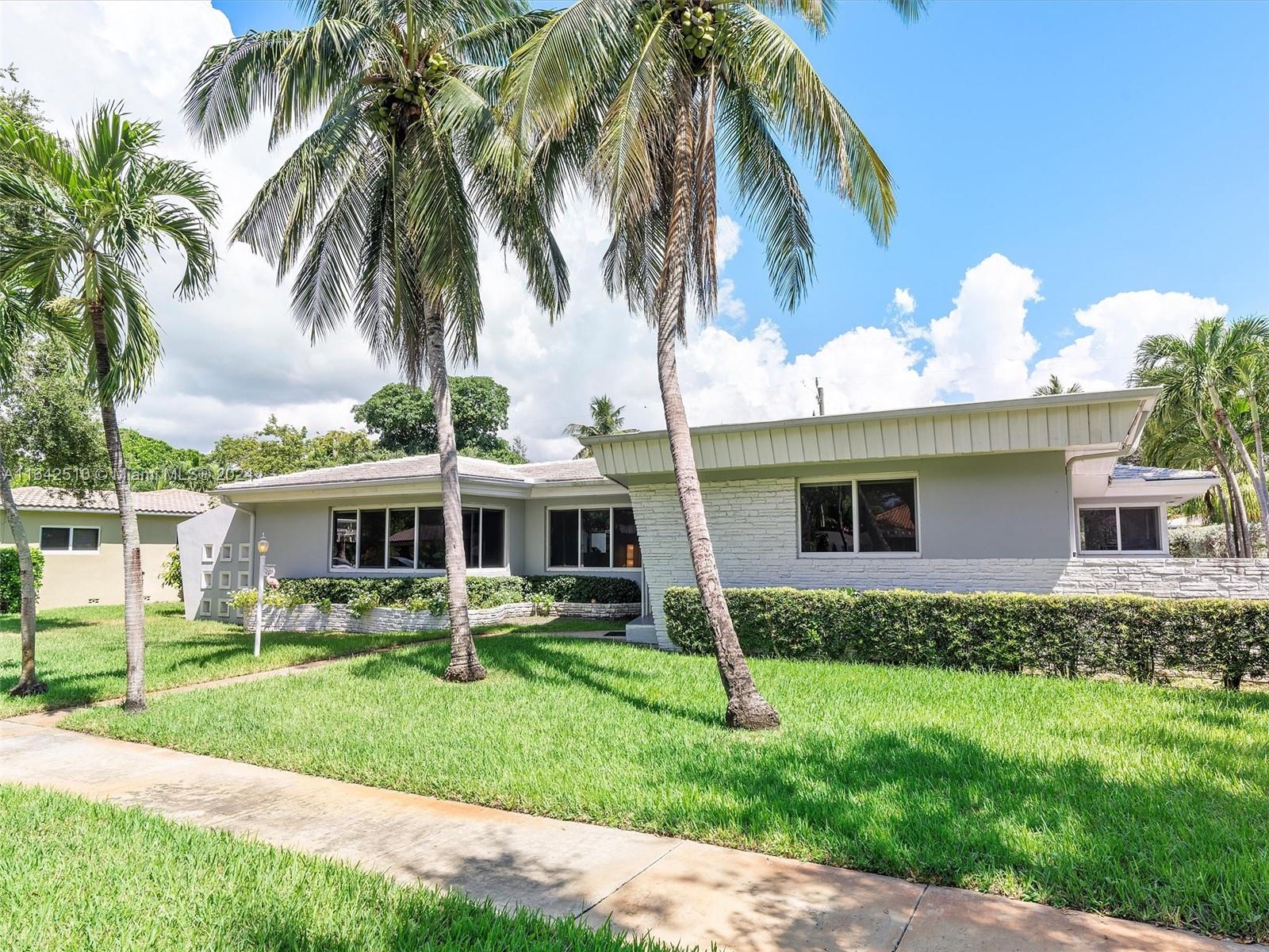 Back on Market, Buyer Financing Fell Through! Miami Shores prime location! Original mid-century details coupled with a modern, open layout make this home a rare opportunity for today's buyer. Enjoy a large formal living room, open kitchen w/breakfast bar, dining room, and light-filled family room—ideal for gatherings. High ceilings & terrazzo floors create a breezy ambiance, while spacious bedrooms, a 2-car garage and ample storage give you room to spread out. An enclosed patio overlooks the pool centered on a 10,000 ft lot, perfect for relaxing or entertaining guests. Impact windows, new electrical, zoned AC add to the value. An easy commute to downtown Miami and the beaches. Don’t miss the chance to discover this mid-century modern home in a non-flood zone of Miami Shores Village.