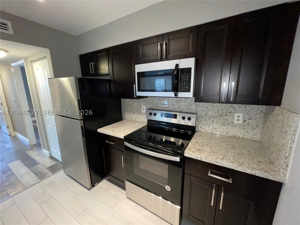 Photo of 2831 N Oakland Forest Dr #101, Oakland Park, FL 33309 (MLS # A12044827)