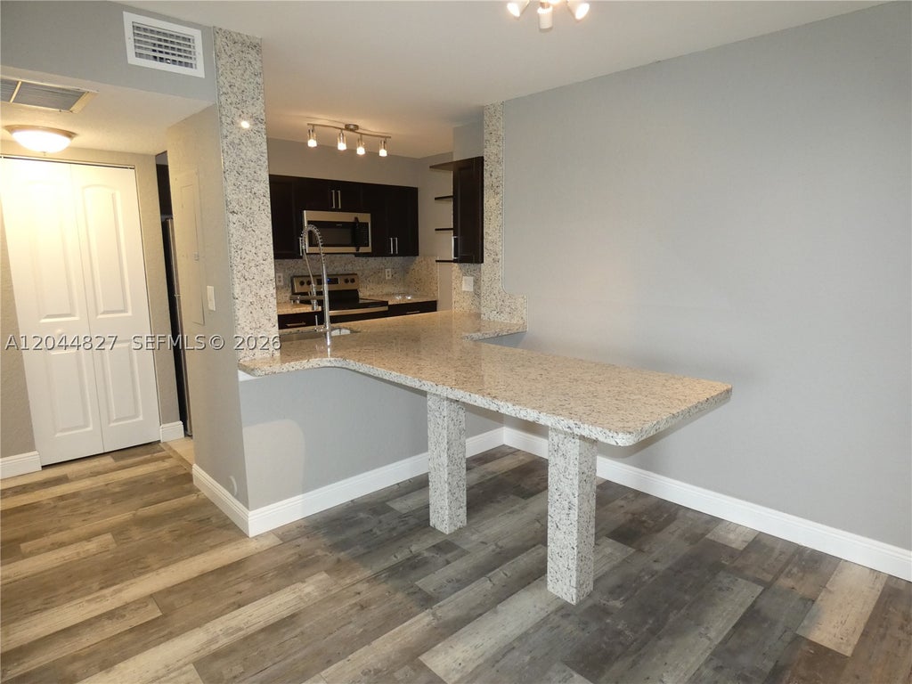 Photo of 2831 N Oakland Forest Dr #101, Oakland Park, FL 33309 (MLS # A12044827)