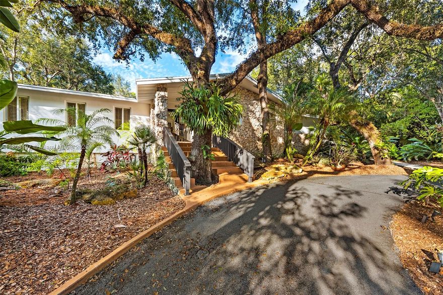 Lowest Price/SqFt in Pinecrest Under $3.5 million! The “Orchid House” delights in Devonwood - a Pinecrest enclave often referred to as “Coconut Grove in Pinecrest.” This cozy & elegant residence w/ 5 Beds + Den + Office, 4.5 Baths features exceptional natural lighting, new roof, and complete impact windows. The home centers around the kitchen w/ SubZero built-in refrigerator, breakfast rm, & seamless connection to living & dining rooms. Located on the main level, the spacious primary suite has 3 closets, dressing area, tub, and a balcony overlooking the heated saline pool (made new in 2022). The ground level features a unique sunroom, oversized family rm, 5th bedroom, sauna, den and office. Among the upgrades: 2-car garage w/ A/C, powder bath and more. Inquire for 3-D Tour & Video.