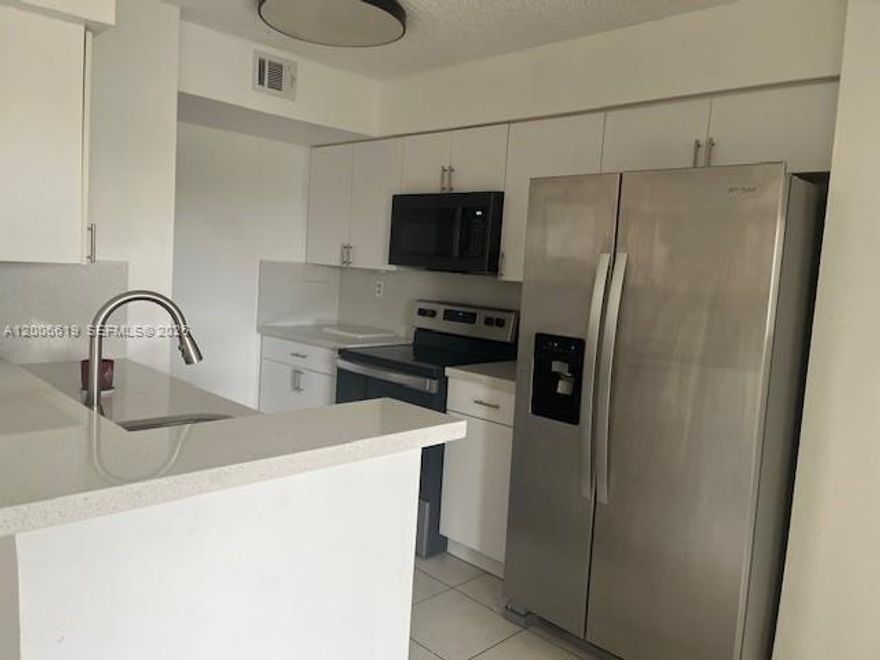 Nice 2/2 on the 5th floor with remodeled kitchen with new soft close cabinets & quartz countertops, neutral tile throughout, stackable washer & dryer inside the unit plus additional laundry facilities on site if needed. Located in a peaceful neighborhood with a guard gate for security & pool, children's play area & no water bill. Close to all the West Kendall shopping, restaurants & local bus service. Great for an owner occupant or an investor, with a low condo fee.